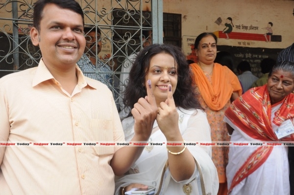 File Pic : BJP state president and local MLA Devendra Fadnavis and his wife appear happy after locking their votes in EVM.
