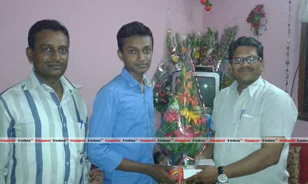 Shubham Patil, first merit holder being felicitated by the staff of Nitin Gadkari